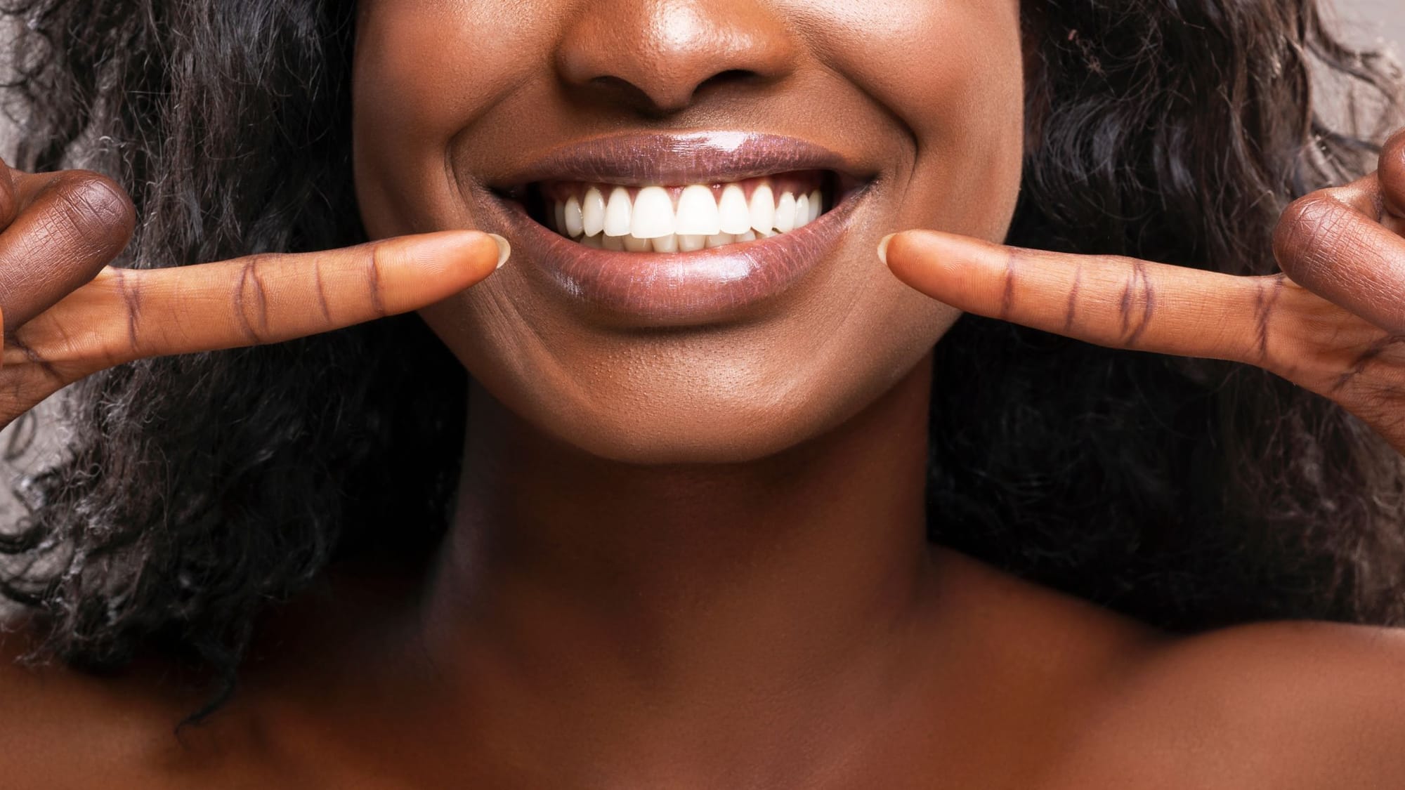 A woman with with white teeth smiling