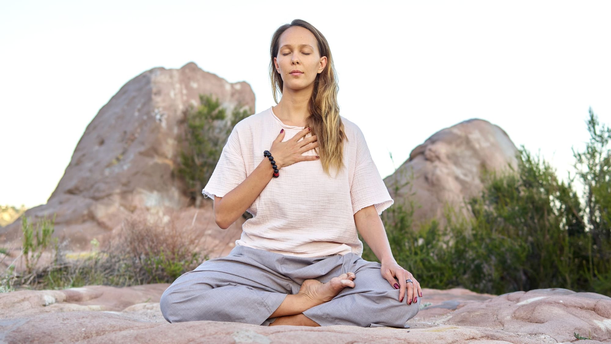 Woman practicing yoga in nature - Somatic Healing - Sage Sistas