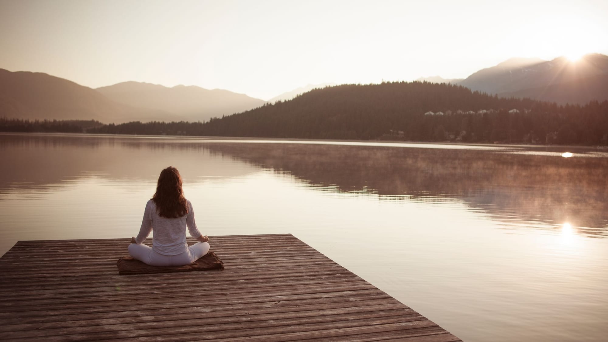 a woman meditating by the lake - Holistic Healing In German New Medicine - SageSistas